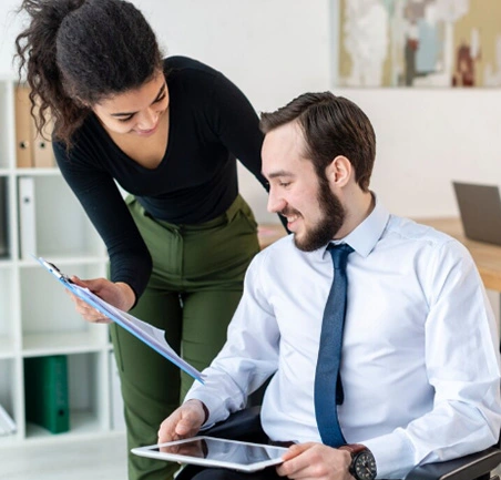 Maestría en Gerencia Integral de la Calidad y Productividad 2 Profesionales analizando gráficos y reportes de productividad empresarial en equipo.