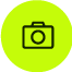 Ícono circular verde con símbolo de cámara fotográfica.